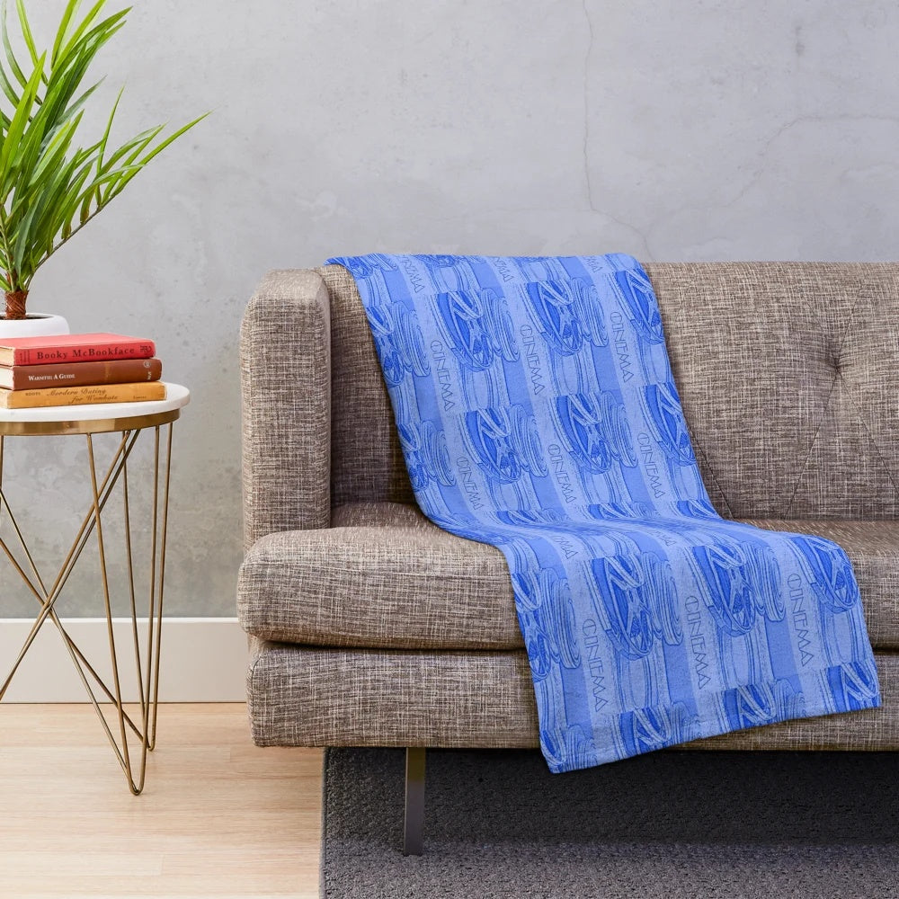 Blue plush blanket with a repeating cinema film reel pattern
