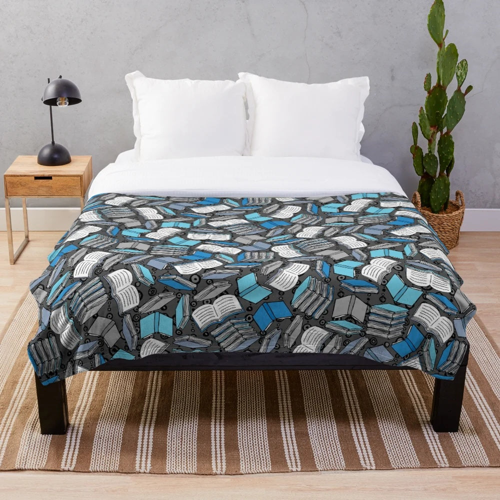 Plush blanket with a sketch-style book and reading-themed pattern