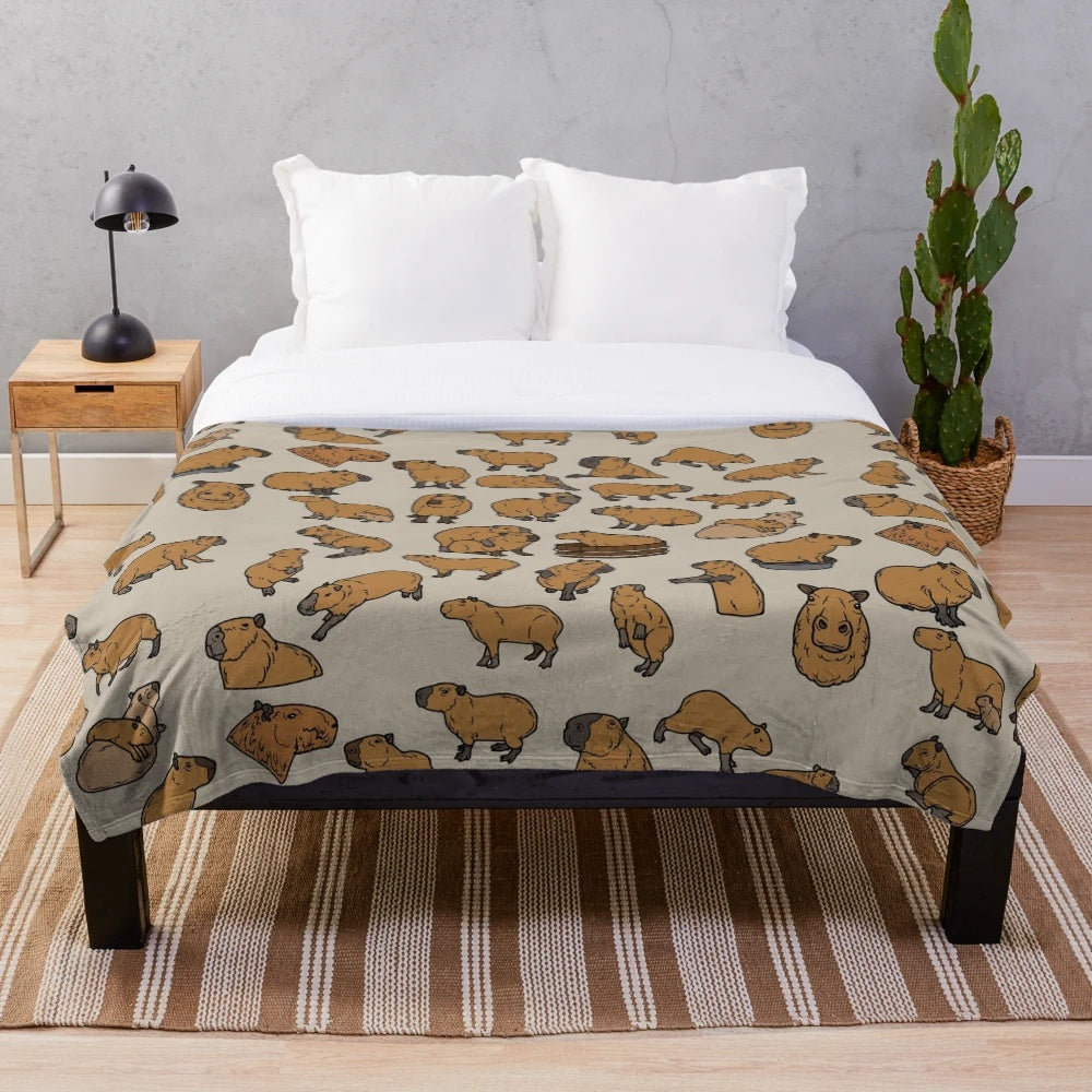 Cozy capybara plush blanket featuring a cute, repeating pattern of the lovable South American rodent
