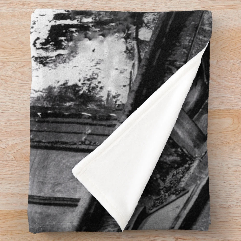 Cozy cinema plush blanket featuring a vintage black and white cityscape with a movie theater
