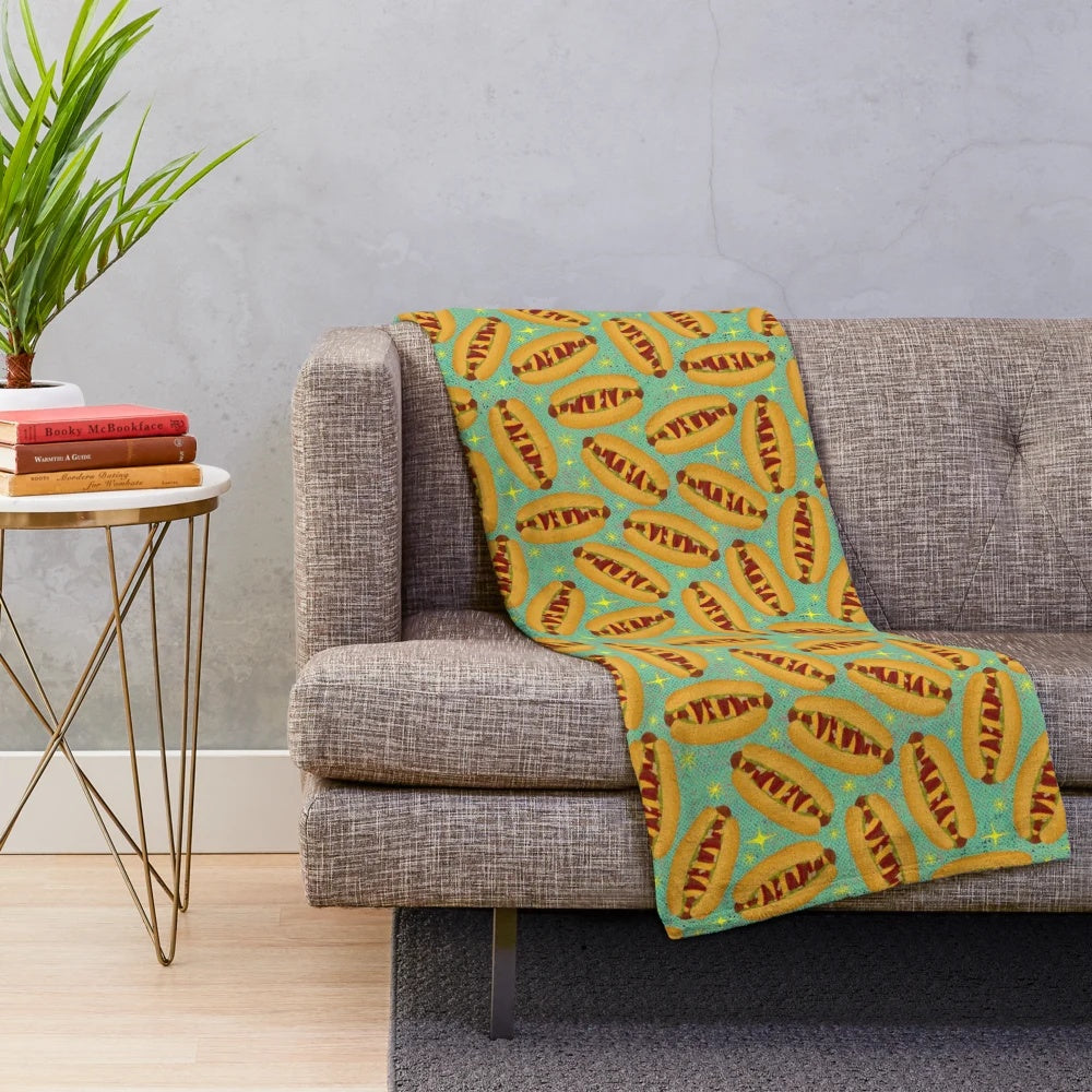Plush blanket featuring a retro-style hot dog design, perfect for movie nights and nostalgic vibes.