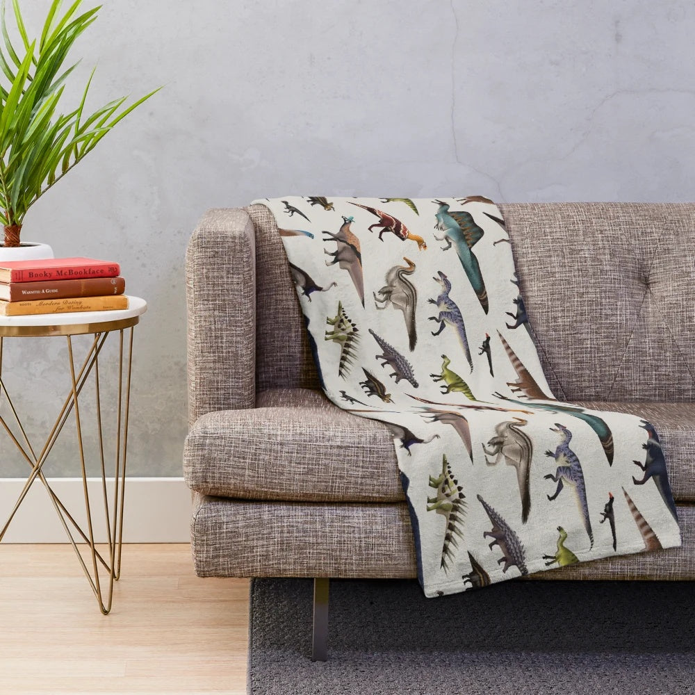 Dinosaur plush blanket with various prehistoric creatures