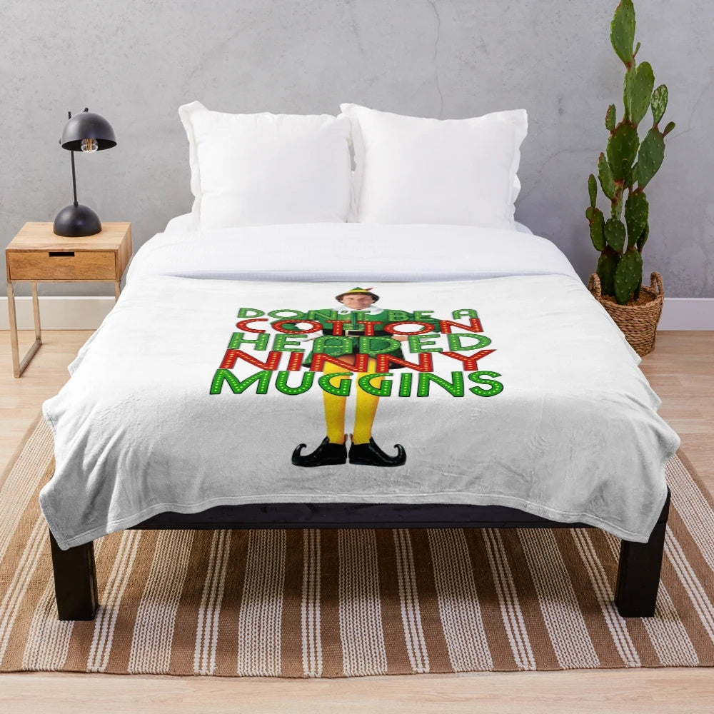 Elf-inspired plush blanket featuring the "Cotton Headed Ninny Muggins" quote from the Christmas movie