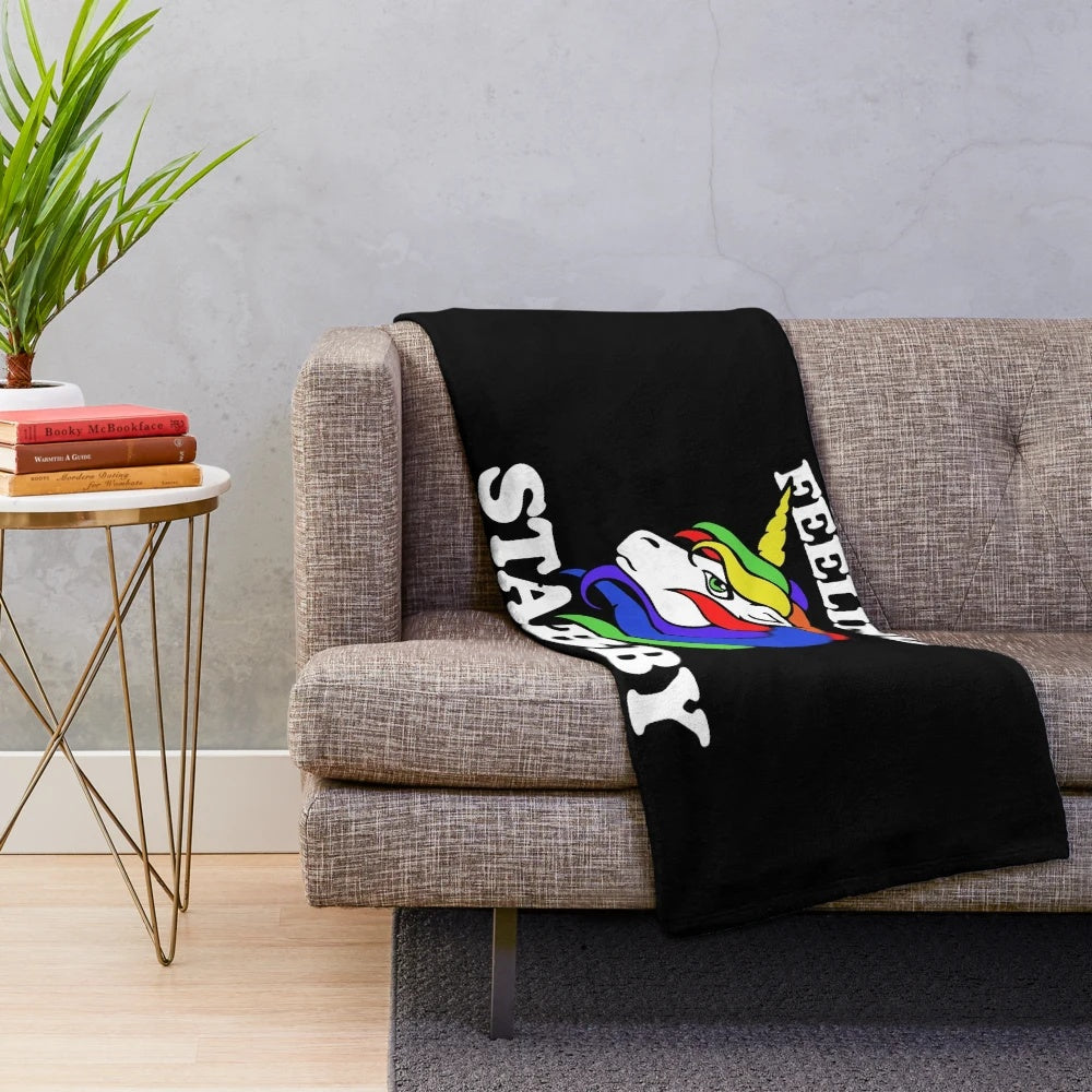 Plush blanket with a unicorn design and rainbow colors