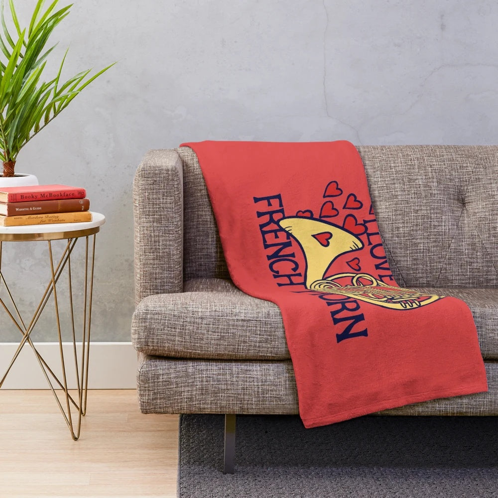 Soft and cuddly plush blanket featuring a French horn design for music lovers