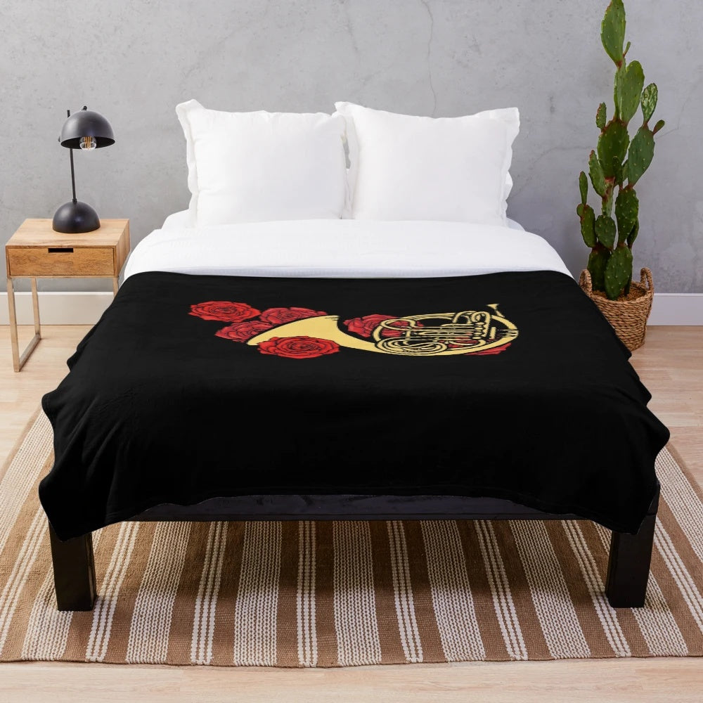 Soft plush blanket featuring a french horn design for music lovers
