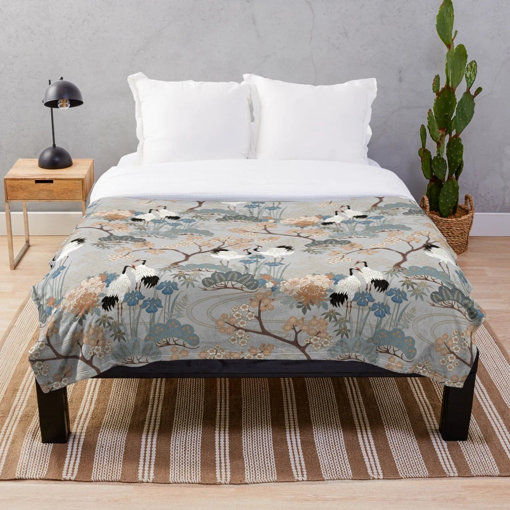 Gray plush blanket with Asian-inspired floral design and red-capped cranes