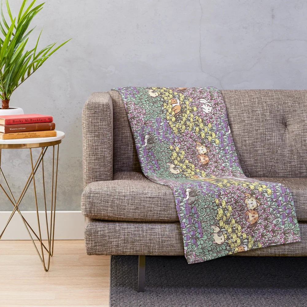 Soft and fluffy guinea pig plush blanket with a vibrant floral garden pattern