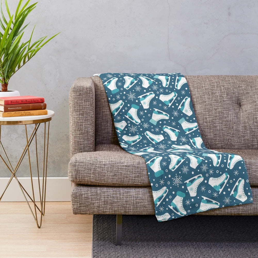 Plush blanket featuring ice skates and snowflakes design