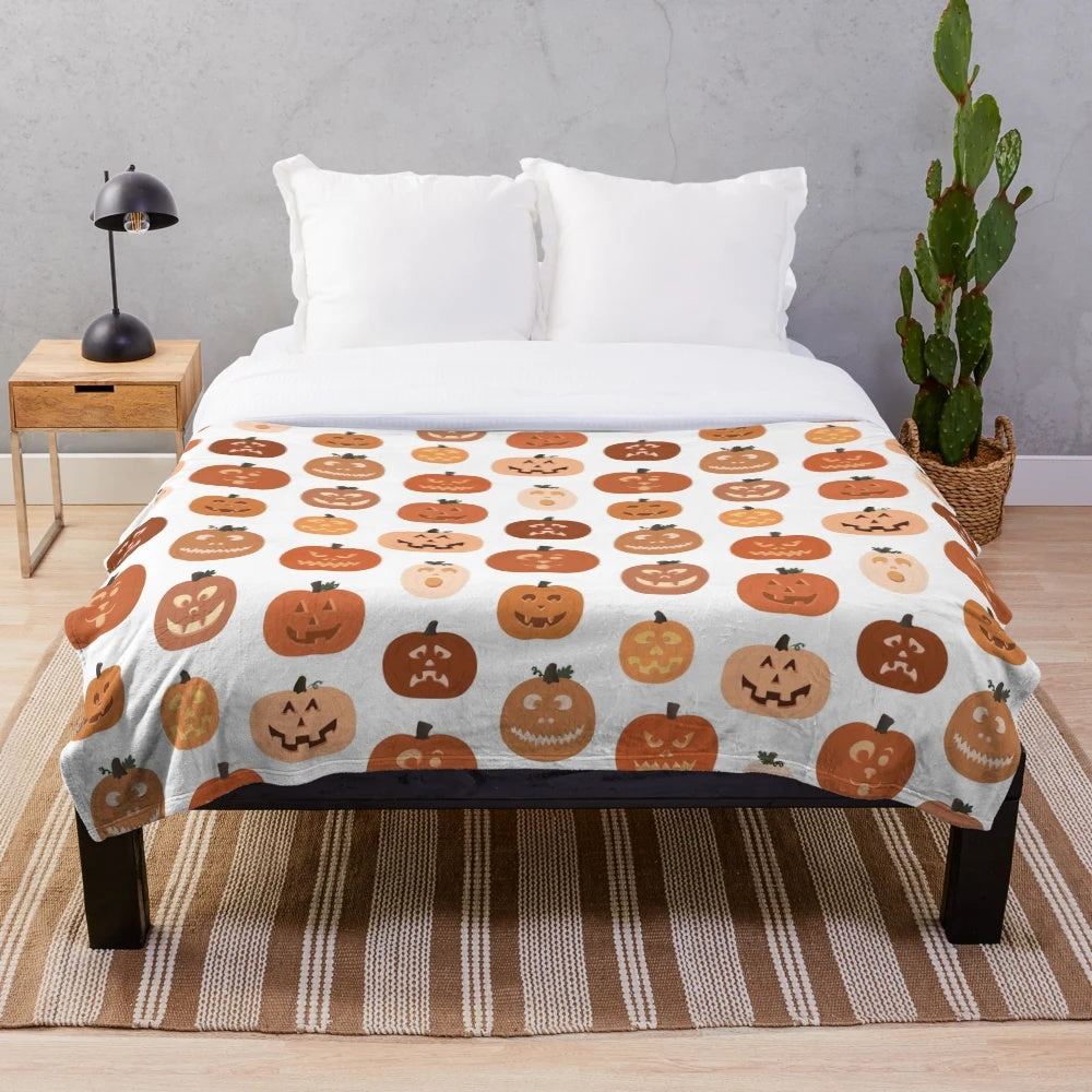 Plush blanket featuring a pattern of cute jack o' lanterns