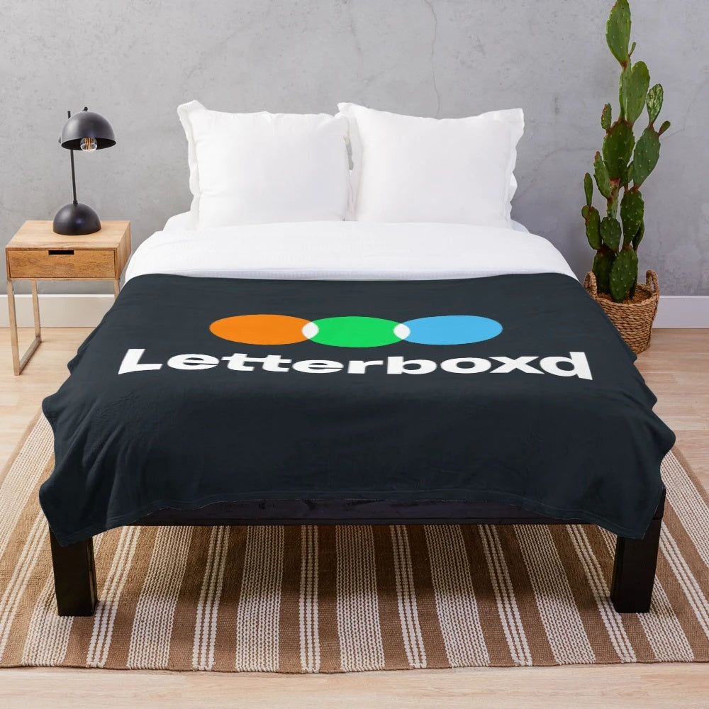 Soft, black and white plush blanket featuring the Letterboxd logo for movie fans and cinephiles