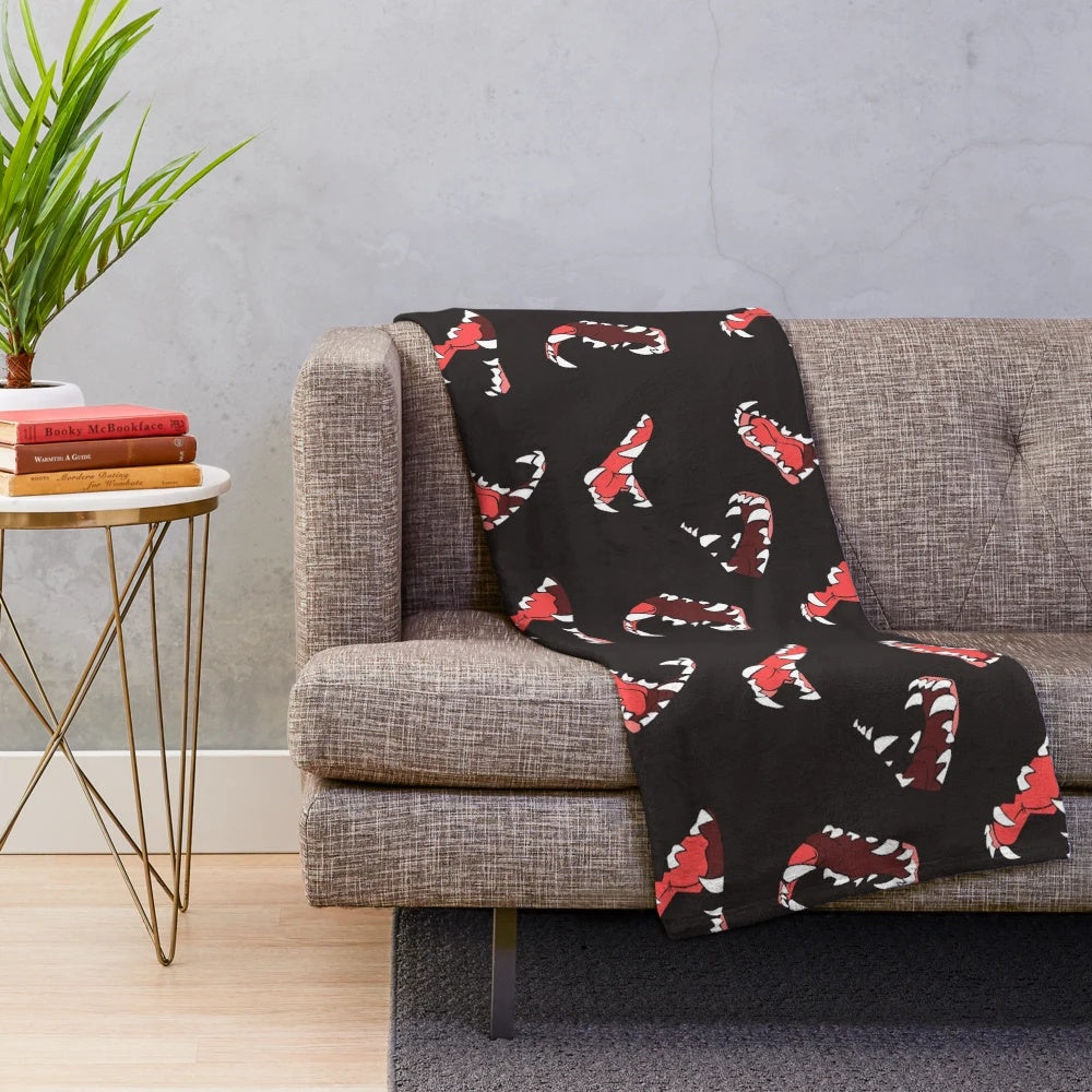 Maws Plush Blanket with a wolf-themed design featuring canine teeth and fur