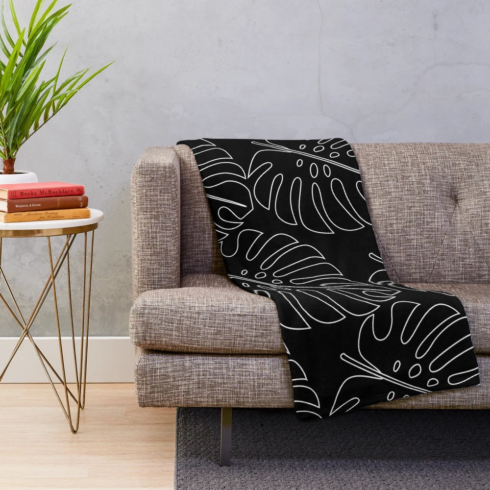 Minimalistic monstera plush blanket with tropical leaf pattern