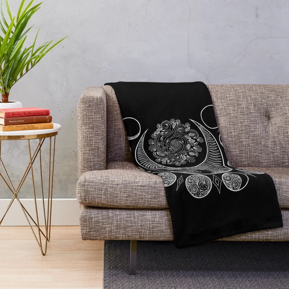Plush blanket with a moon phases pattern in pastel colors