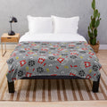 A cozy plush blanket featuring a movie night and snack themed design
