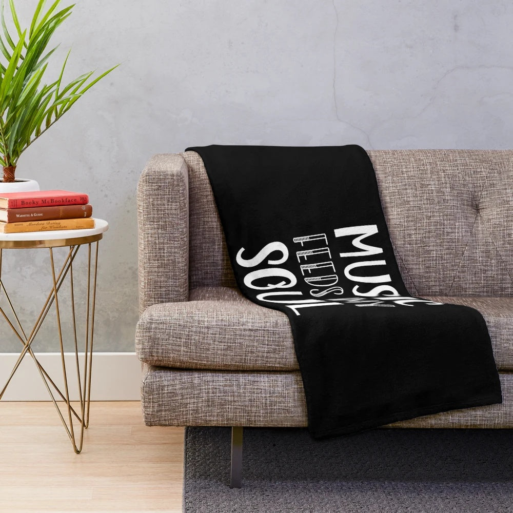 Plush blanket with music-inspired white and black text design