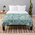 Mint green nautical plush blanket with sailing and coastal design elements