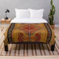 Navajo-inspired plush blanket in red, yellow, and brown southwestern pattern