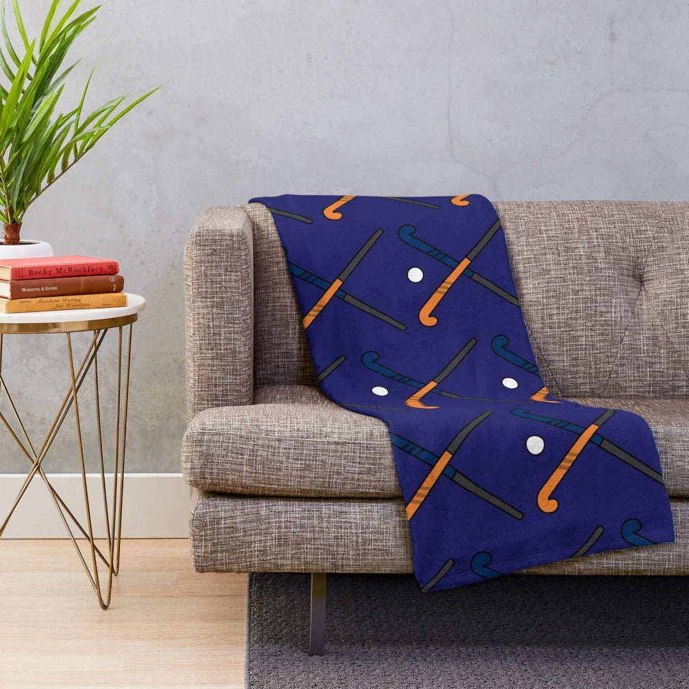 Navy and orange plush blanket with field hockey design