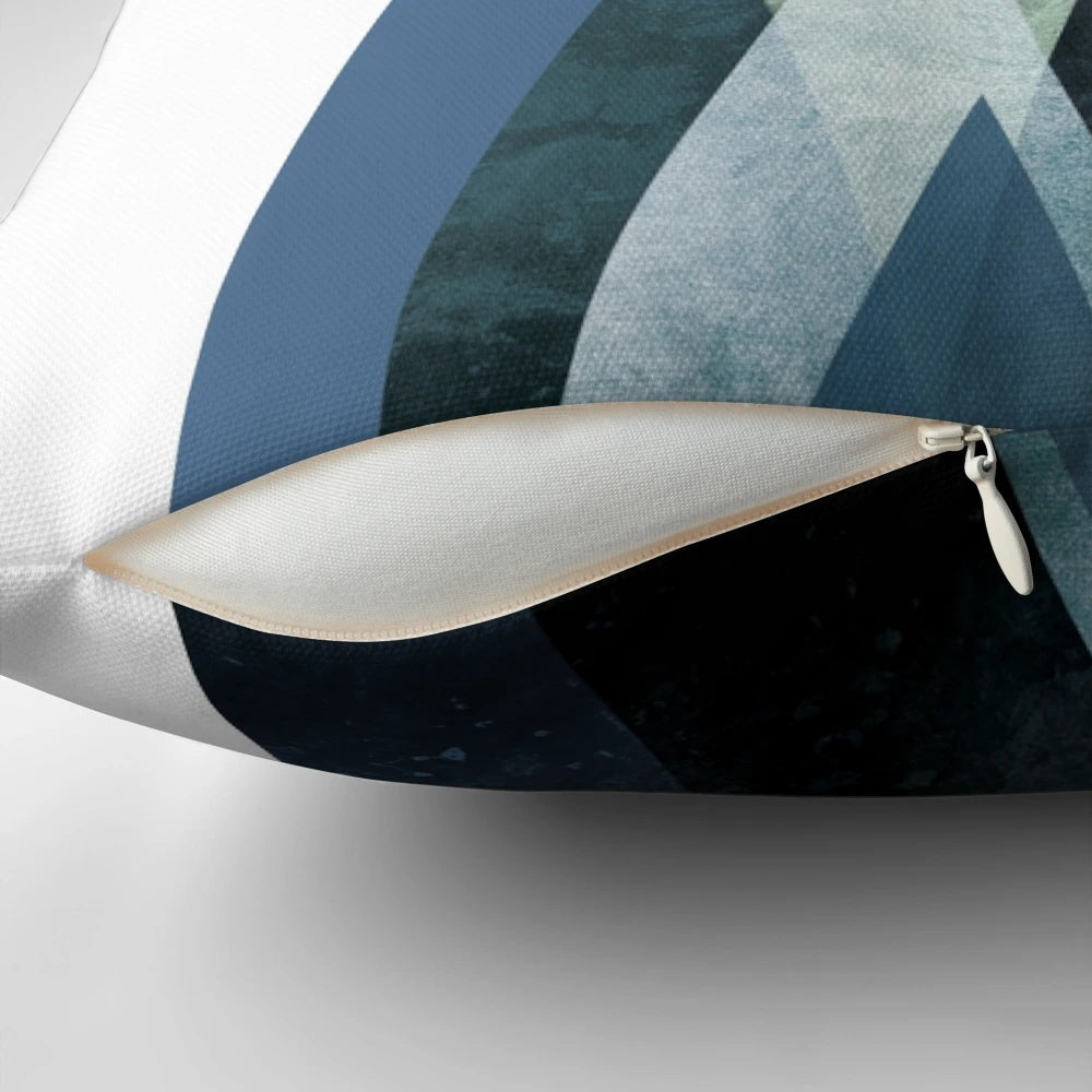 A navy blue and hunter green minimalist mountain art pillow with a simple, modern design.