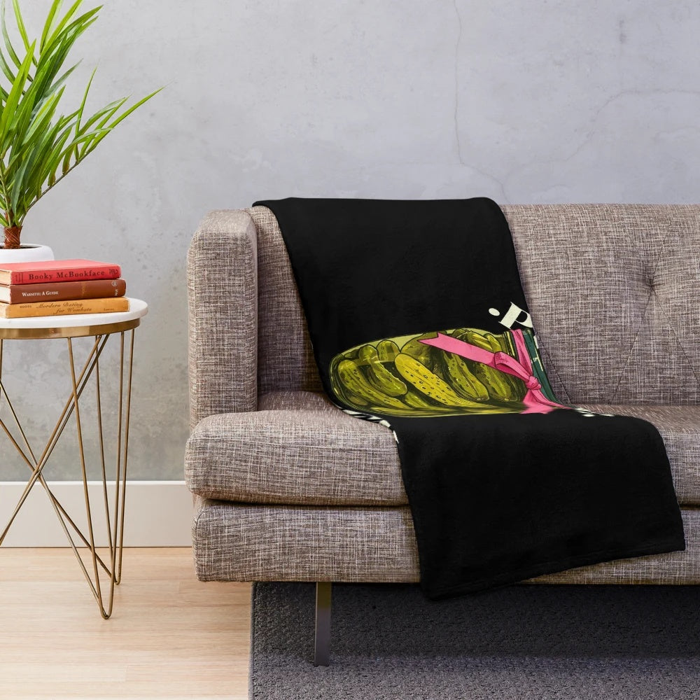 A cozy plush blanket featuring a playful pickle design, perfect for pickle lovers and pickleball fans.