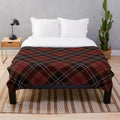 Cozy plaid blanket with traditional Scottish tartan pattern in red, white, and black
