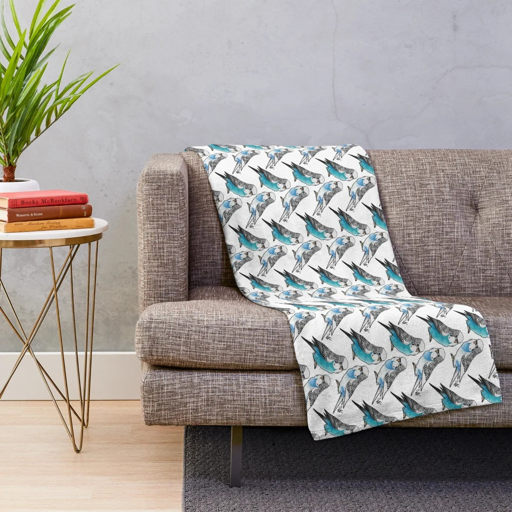 Two adorable blue budgies on a plush blanket