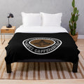 Plush blanket with "Overworked Under Caffeinated" design for coffee lovers