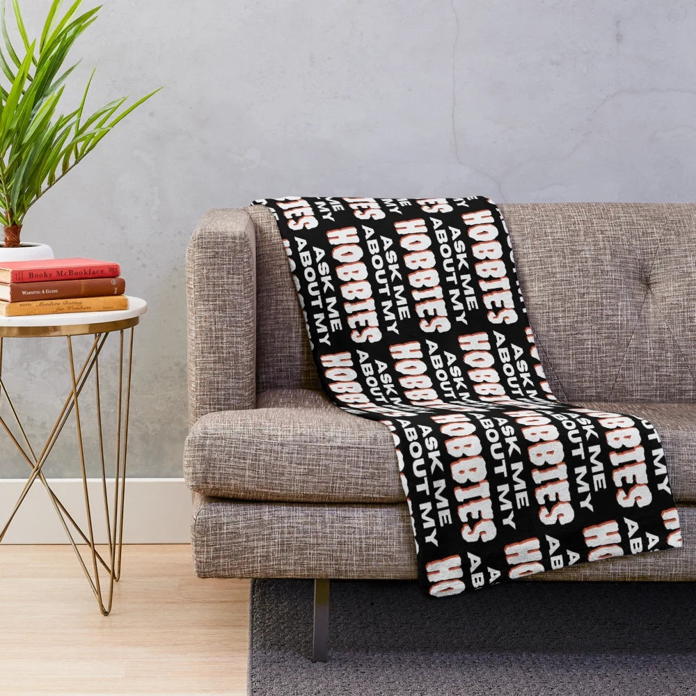 Plush blanket with "Ask me about my hobbies" design