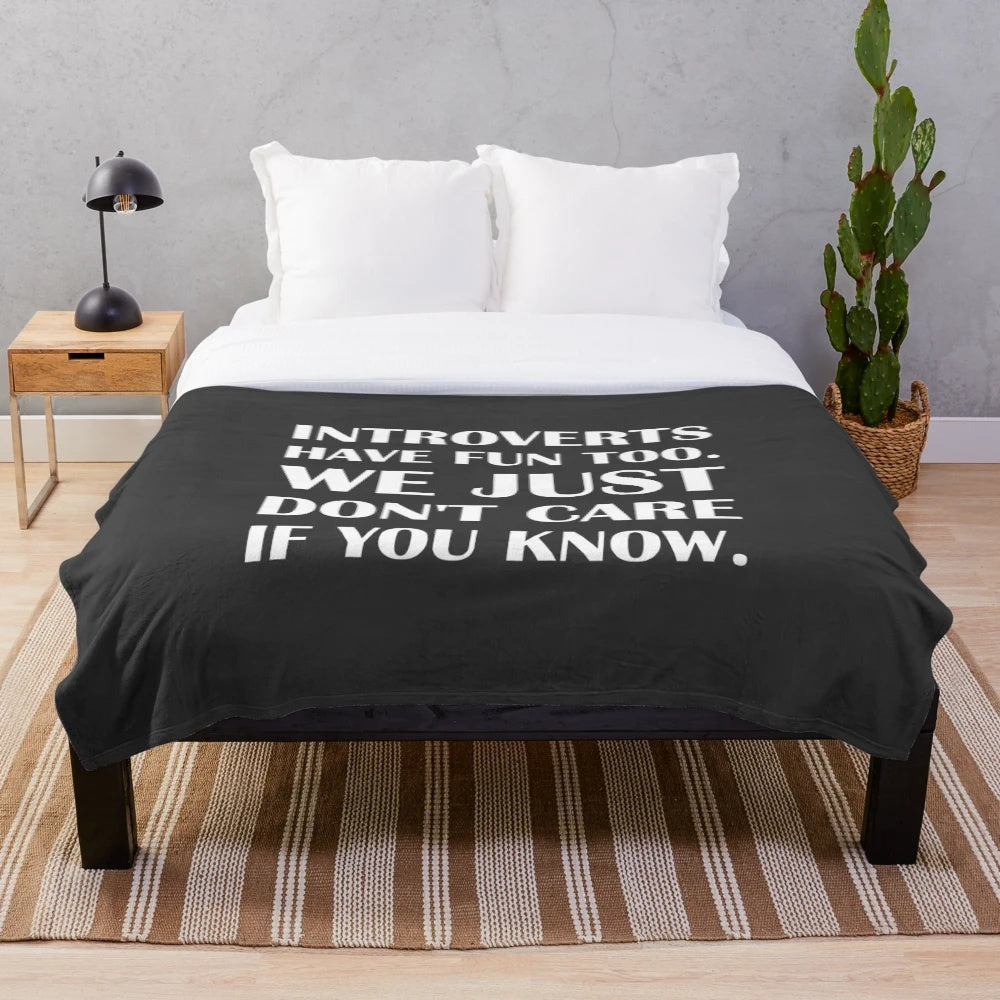Cozy introvert plush blanket with the text "Introverts Have Fun Too. We Just Don't Care If You Know.