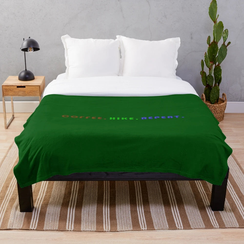 Cozy plush blanket with "Coffee. Hike. Repeat." design