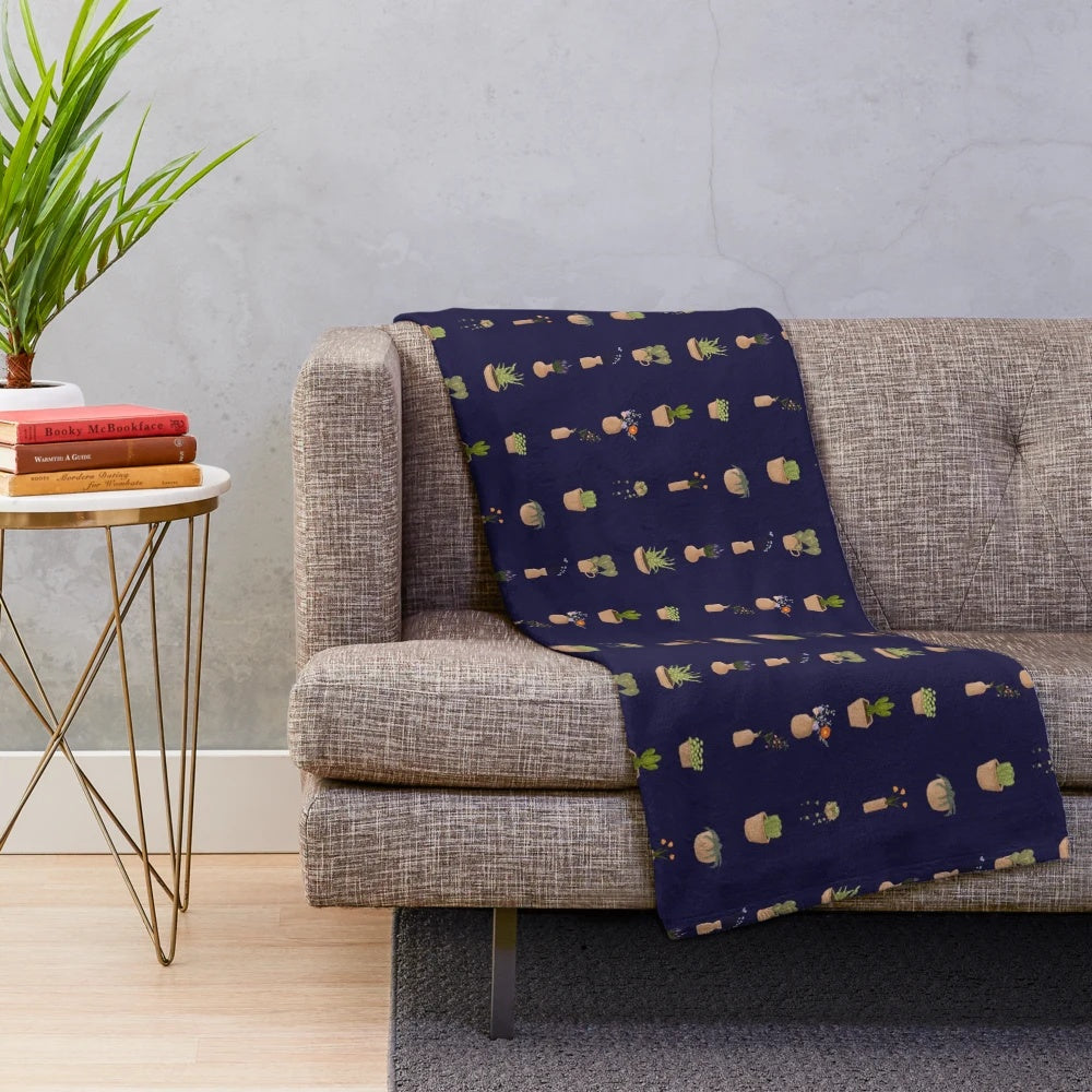 Plush blanket with a design featuring potted plants and gardening tools