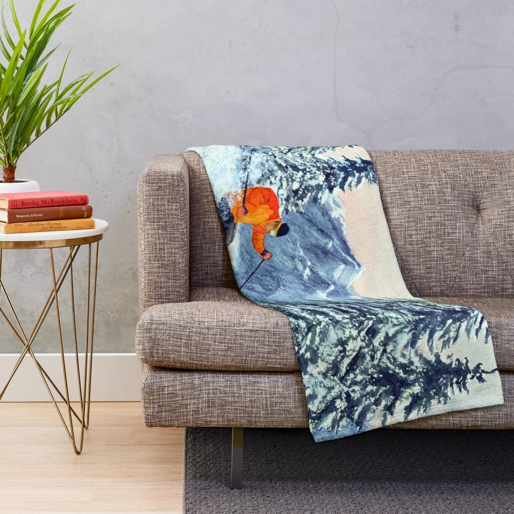 Skiing-themed plush blanket featuring snow-capped mountains and ski icons