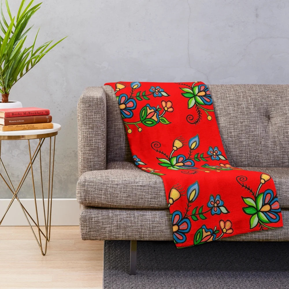 Plush blanket with floral and blue acrylic painting design inspired by indigenous and metis art from Saskatchewan