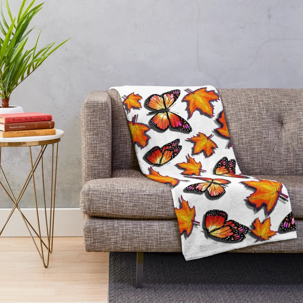 Plush blanket featuring monarch butterflies and vibrant orange fall leaves