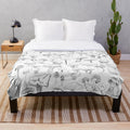 Soft, grey plush blanket with a whimsical mushroom pattern design
