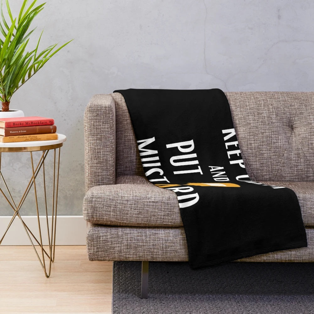 A plush blanket featuring a mustard and ketchup condiment pattern