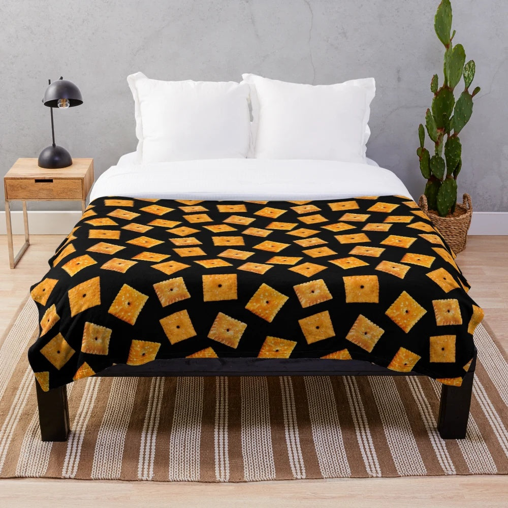 Plush black blanket with an orange square snack pattern design