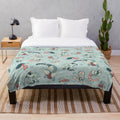 Plush blanket featuring a design of various reptiles and amphibians