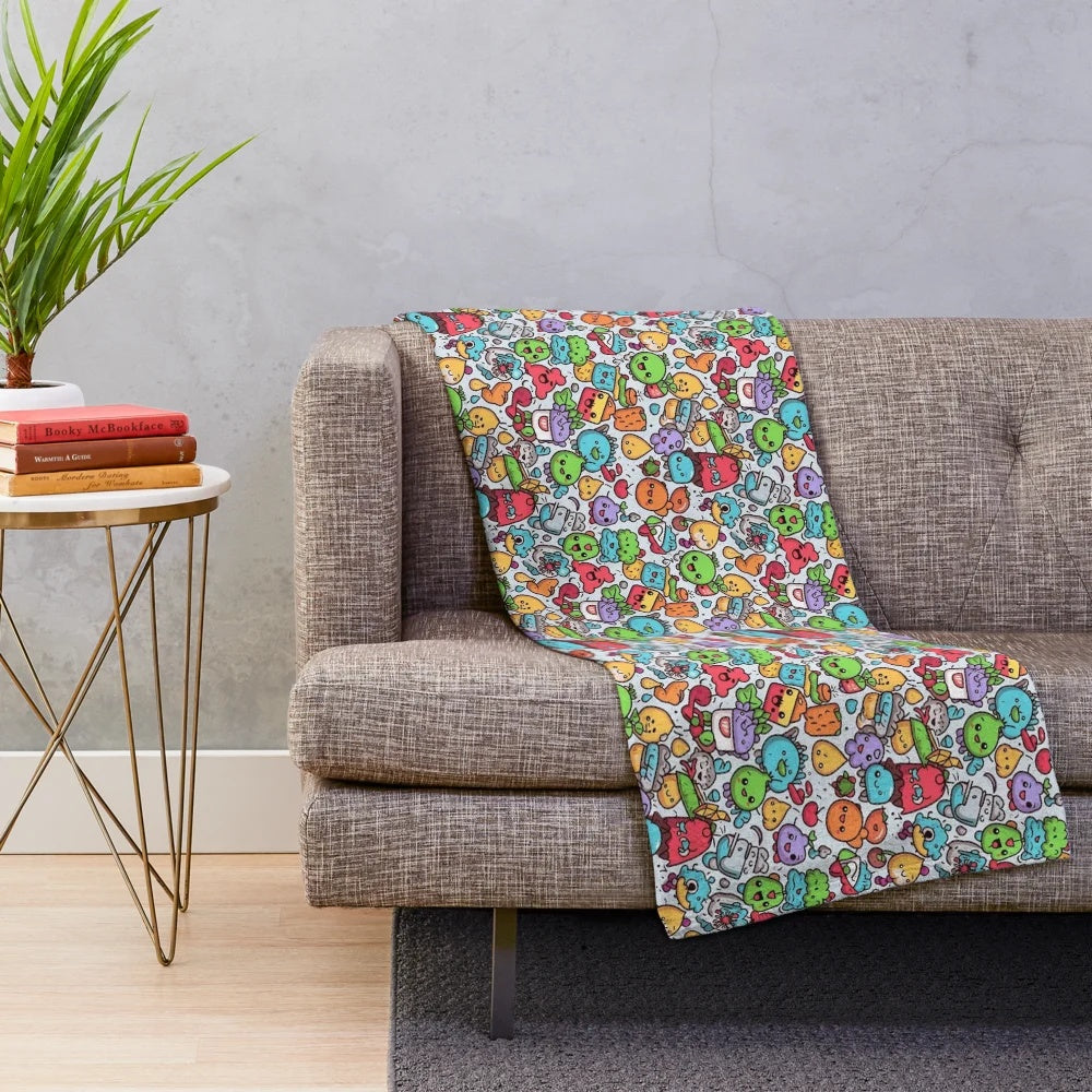Cozy plush blanket featuring a vibrant abstract pattern with cartoon animals and fruits