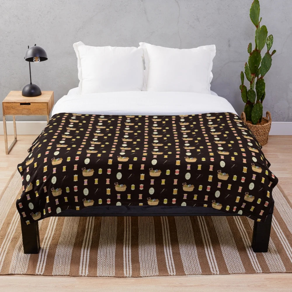 Colorful plush blanket featuring sewing-themed design