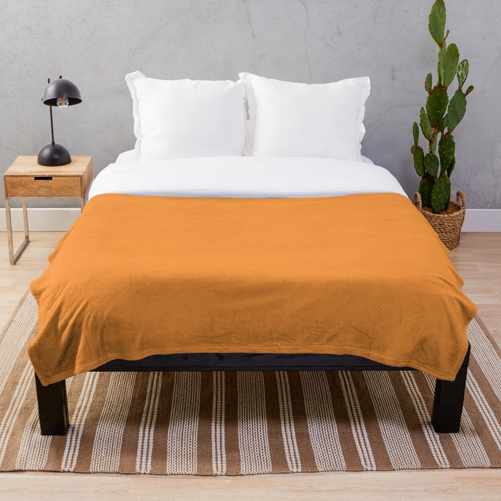 Warm orange watercolor flowers on a cozy plush blanket