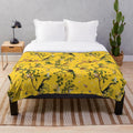 Soft and plush yellow floral monkey-patterned blanket