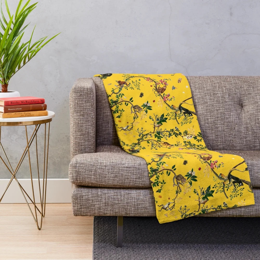Soft and plush yellow floral monkey-patterned blanket