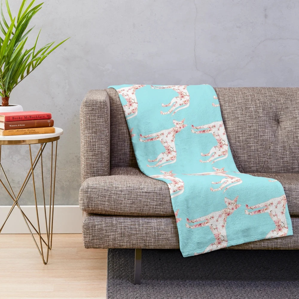 Podenco dog breed on a soft, plush cherry blossom blanket