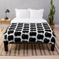 Fluffy black pomeranian dog on a soft plush blanket