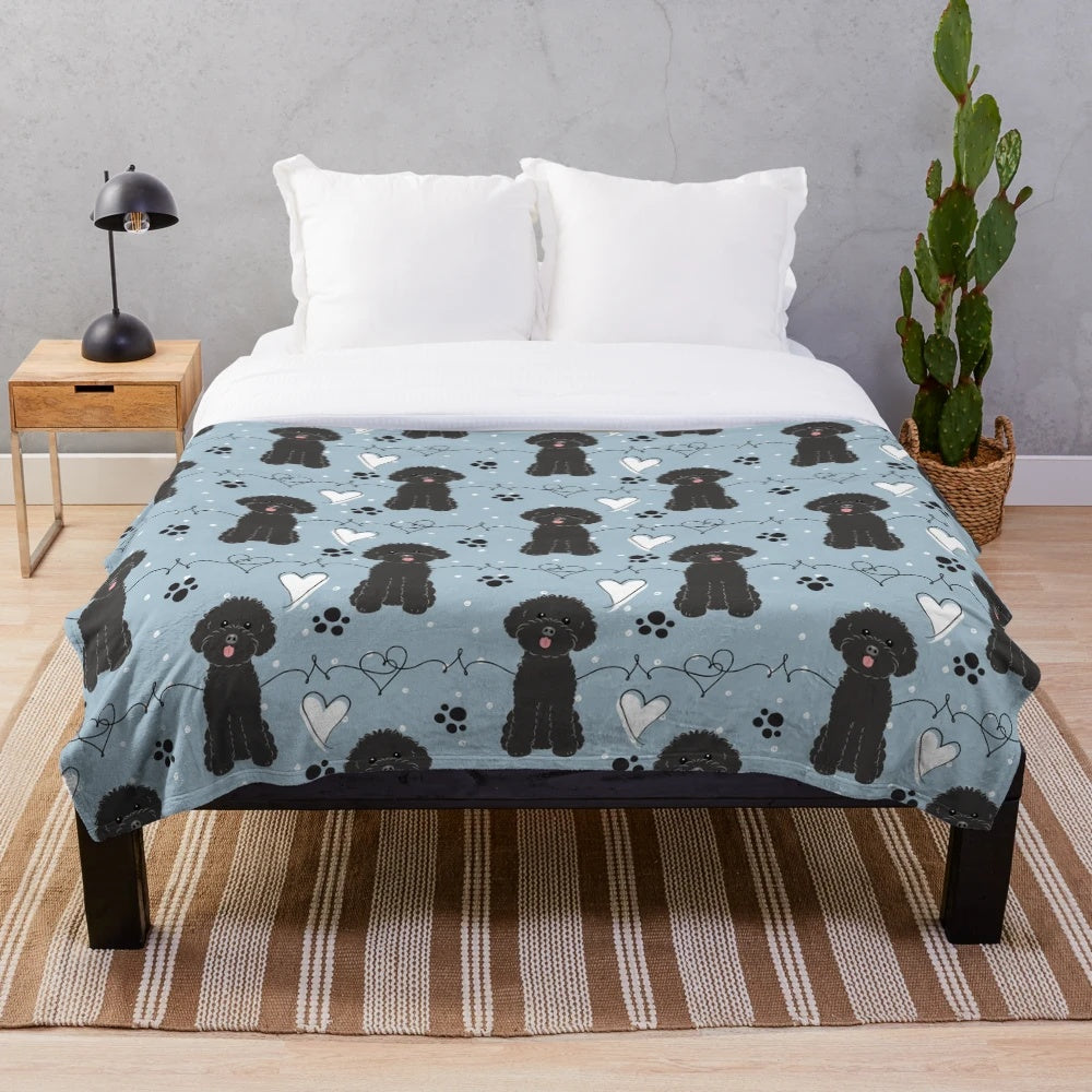 A soft and cuddly plush blanket featuring a poodle design, perfect for poodle lovers.