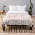 Pumpkin-themed plush blanket in beige and brown tones