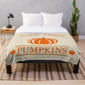 Cozy pumpkin-themed plush blanket for autumn and Thanksgiving decor