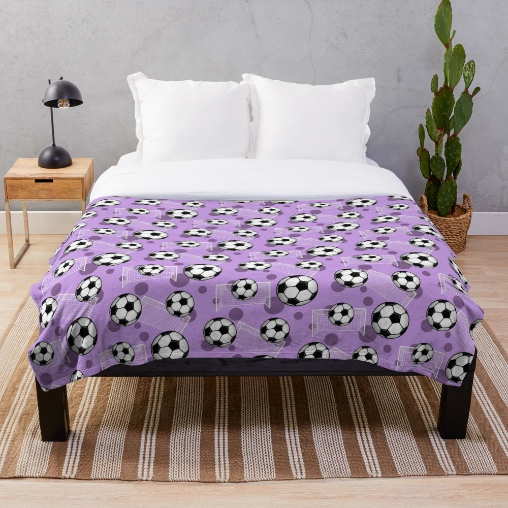 Purple soccer-themed plush blanket with soccer ball and goal pattern
